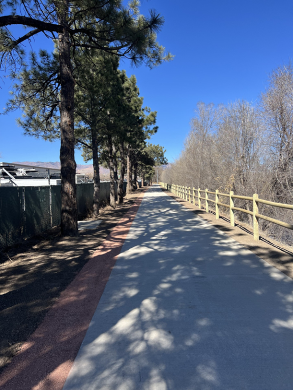 Pikes Peak Greenway after the work done on it, with a freshly paved sidewalk.