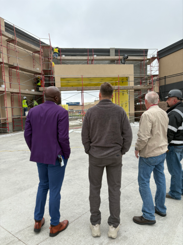 Mayor Yemi, Deputy Chief of Staff Travis Easton, District 2 Councilmember Tom Bailey, and a representative of Venu look at the sound mitigation progress.