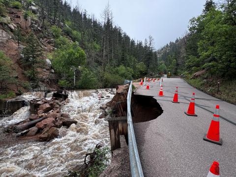 North Cheyenne Canon road with cones marking off the area of road that has crumbled away.