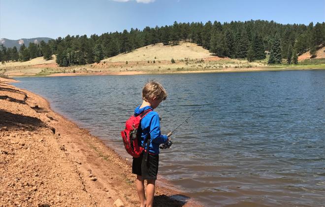 small boy fishing on the edge of the South Catamount Reservoir