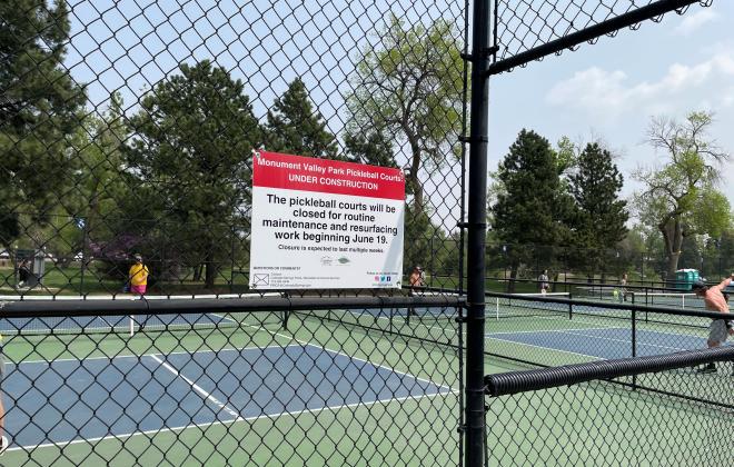 A pickleball court with a sign on it, saying the court is closed