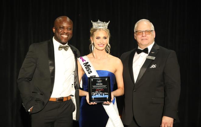 Mayor Yemi Mobolade and Colorado Springs City Councilmembers President Randy Helms present Madison Marsh with the Spirit of the Springs award