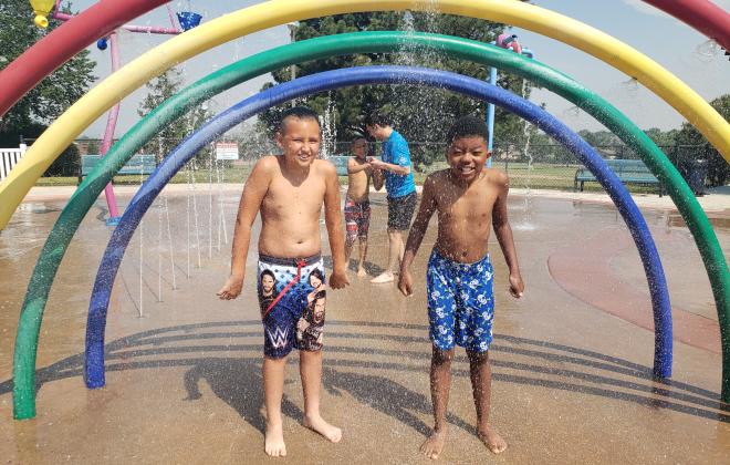 Kids playing in a water playground component