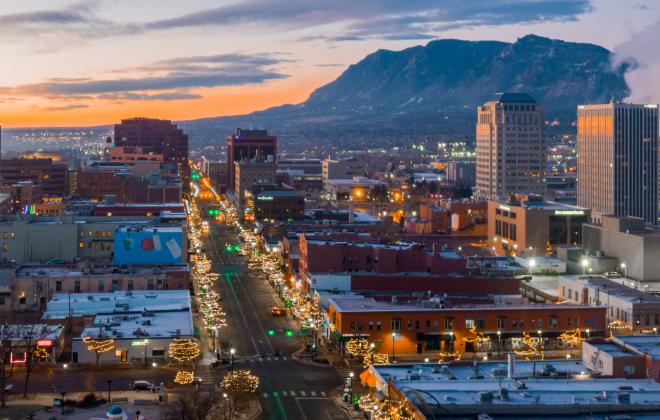 aerial view of downtown colorado springs at night. mountains in the background